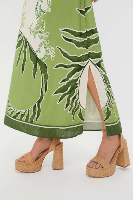 Ireland Green Wess Midi Dress features a chic botanical-print, side slit, and tan woven platform heels, embodying effortless elegance and classic high-end style for fun occasions.