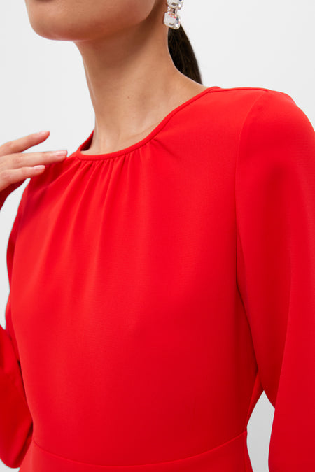 Model in Red Delancey Dress, showcasing a classic, effortless style with a gathered neckline, fitted waist, and elegant long sleeves, perfect for high-end, fun occasions.