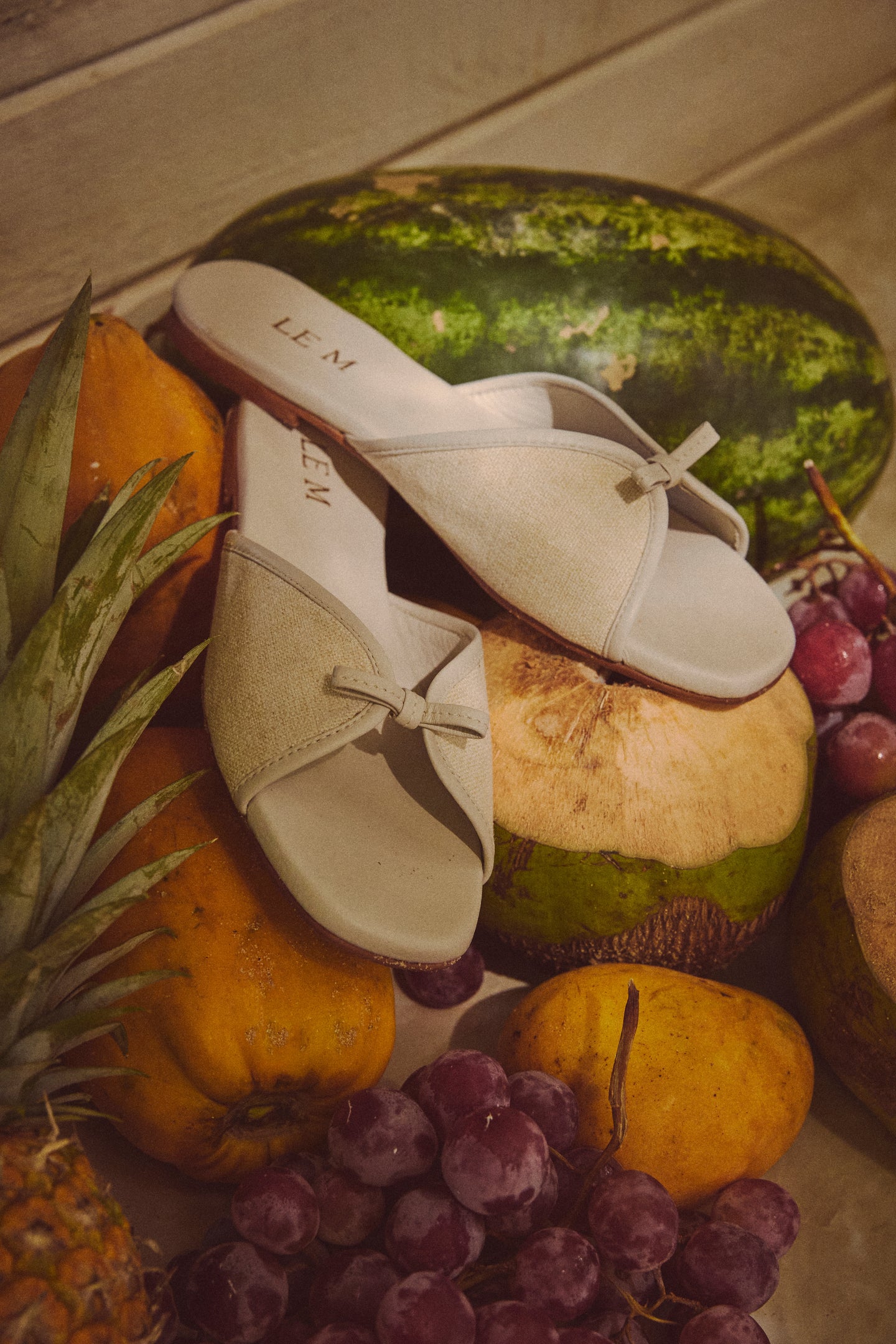 Off White Gianna Flat Sandals are effortlessly classic, styled with tropical fruits, showcasing a fun, high-end design perfect for beach walks and casual outings.
