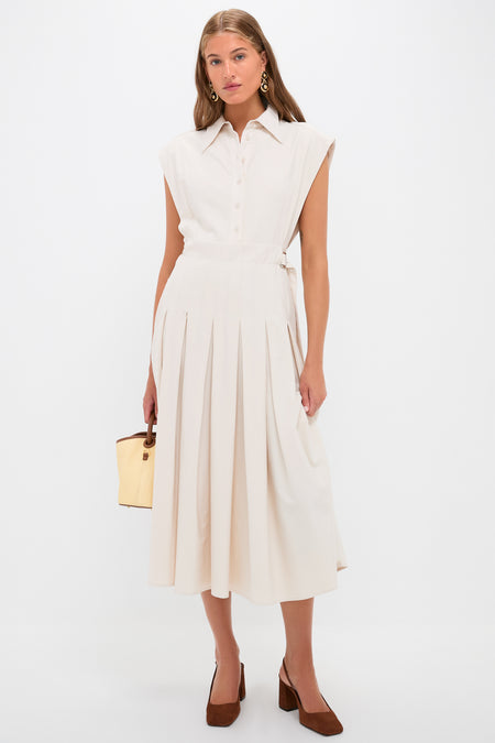 Model showcasing Tortoise 24K Gold Electroplated Circle Drop Earrings, adding a classic, effortless touch to a high-end, fun beige shirt-dress ensemble with chic accessories.