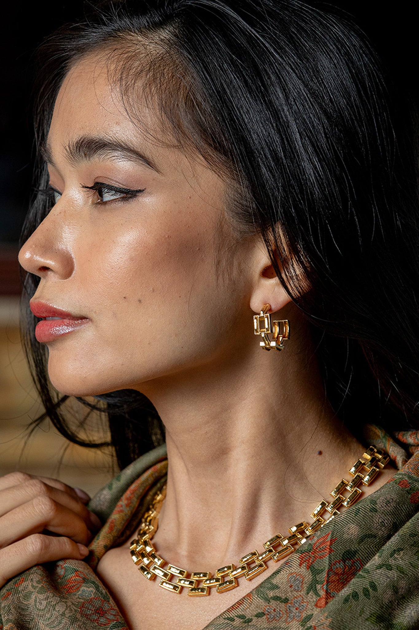 Woman in profile wearing Pathway Hoop Earrings in Gold, featuring classic rectangular links, paired with a matching necklace, exuding effortless, high-end style.