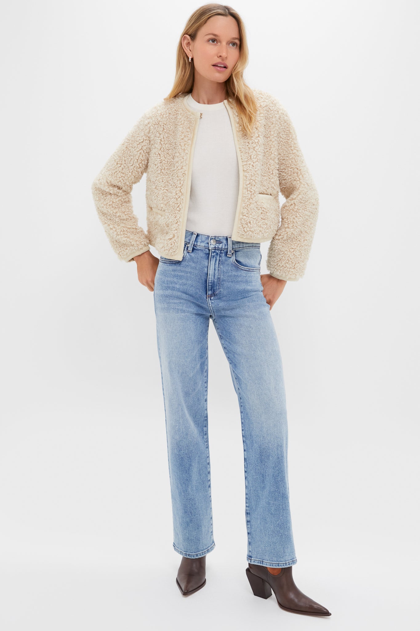 Model wearing Big Chill 90's Mid Rise Straight Ankle jeans, exuding classic, effortless style with a fun, high-end twist in light-wash denim and faux-shearling jacket.