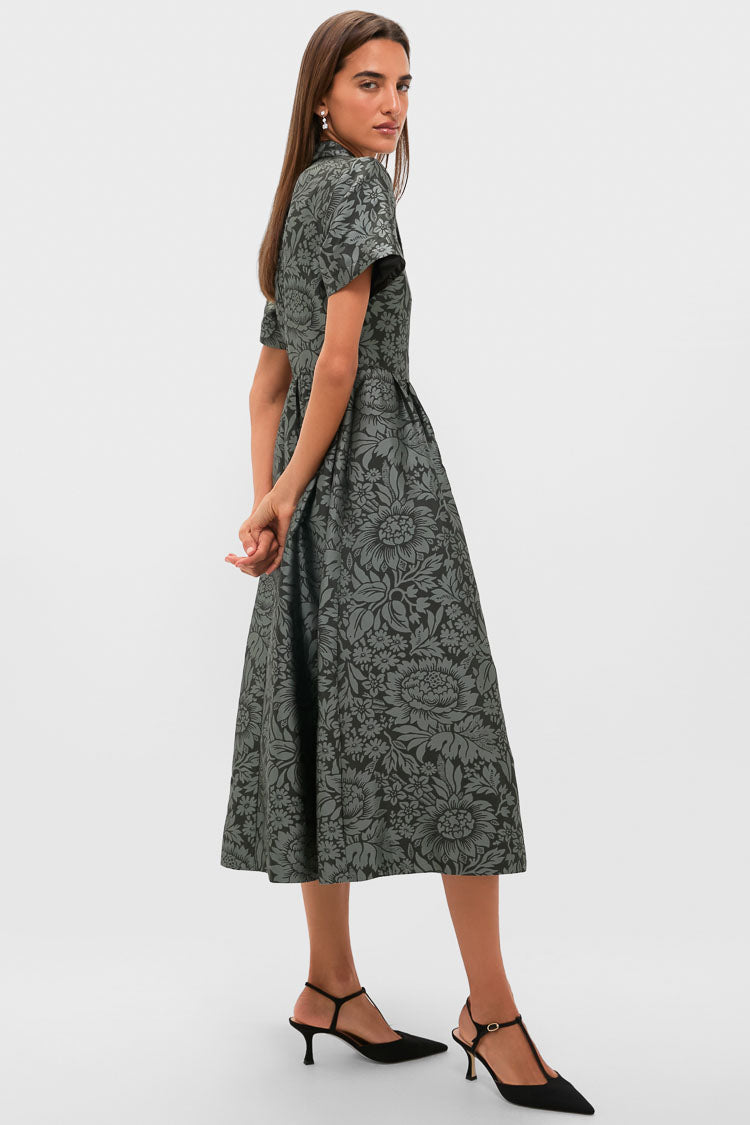 Model in an Emerald Mirasol Jacquard Adelaide Dress, showcasing a classic, effortless silhouette with a fitted waist, flared skirt, T-strap kitten heels, ideal for high-end occasions.