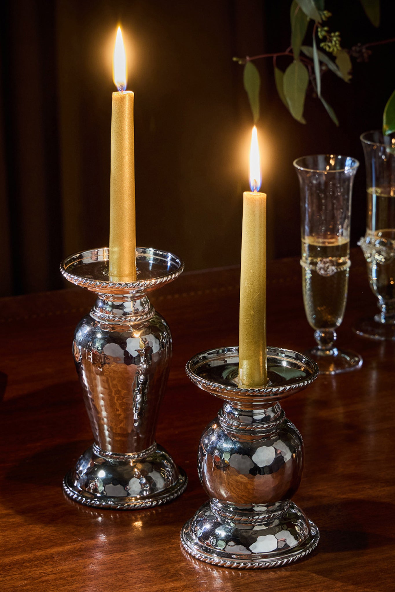 Graham 5 Pillar/Taper Candle Holder: classic hammered-metal design, supporting lit taper candles on a stylish tabletop with champagne flutes, offering an effortless, fun, high-end ambiance.