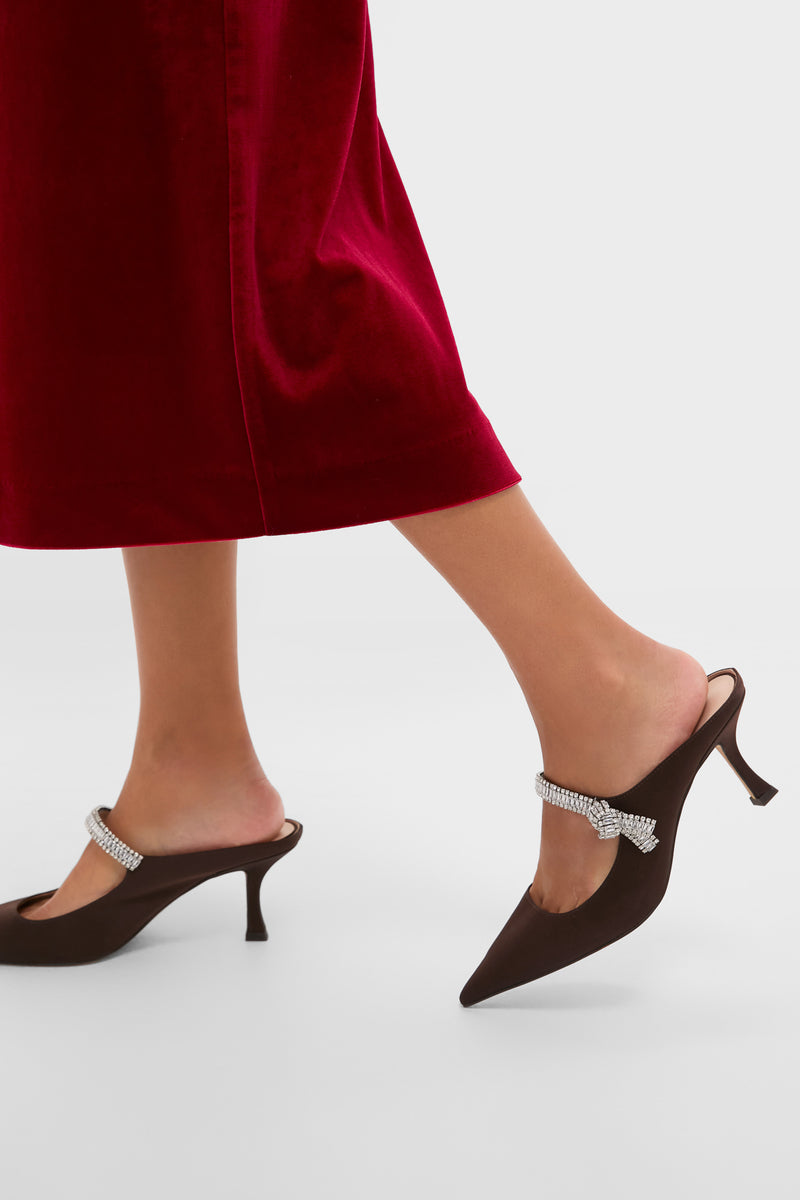 Chocolate Satin Mae Heels exude classic elegance with their dark brown satin finish, effortless pointed-toe design, and fun, high-end crystal-embellished strap. Perfect for glamorous occasions.