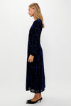 Navy Burnout Velvet Odette Maxi Dress on model; classic, effortless style with long blouson sleeves, fitted bodice, and flowing skirt for high-end, fun occasions.