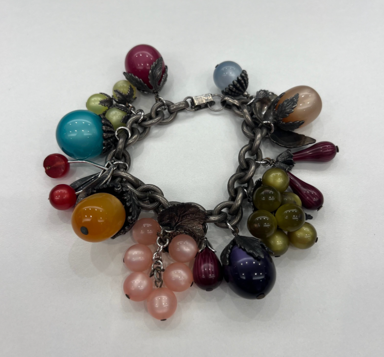 A silver charm bracelet by Tuckernuck Vintage Accessories features colorful glass beads shaped like grapes, cherries, and berries arranged in clusters.