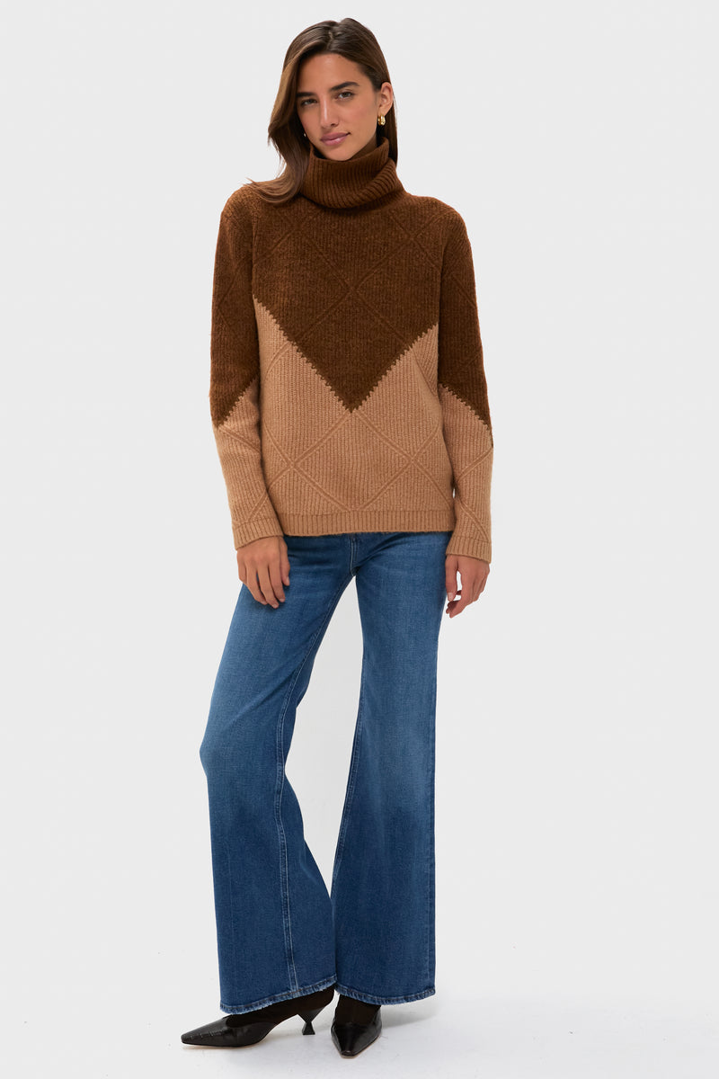 Young woman models a classic Tan & Brown Diamond Demi Turtleneck, effortlessly styled with high-waisted jeans and pointed-toe shoes, embodying fun, high-end casual elegance.