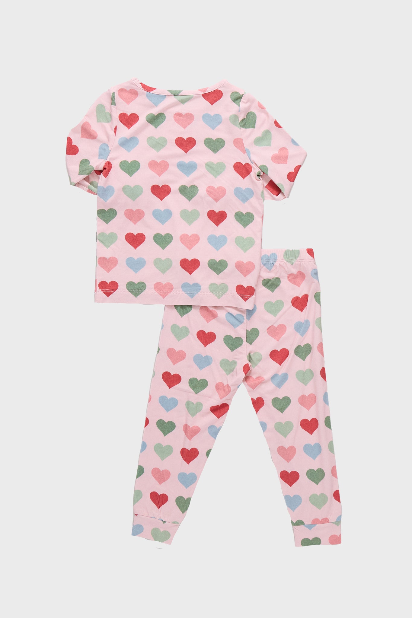 Pink Small Hearts Kids Bamboo Pj Set: A classic, effortless two-piece pajama set featuring a light pink top and pants with fun, colorful heart patterns, crafted from high-end bamboo fabric.