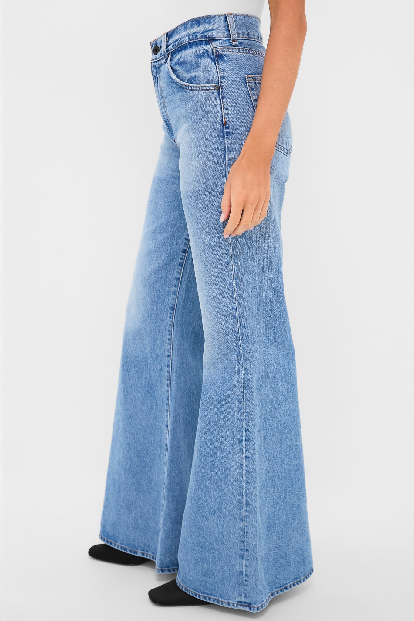 Model wearing Blondie Vandam Jean, featuring a classic high-rise, effortless wide-leg flare, and clean hem, exuding a fun, high-end vibe with sleek Japanese denim.
