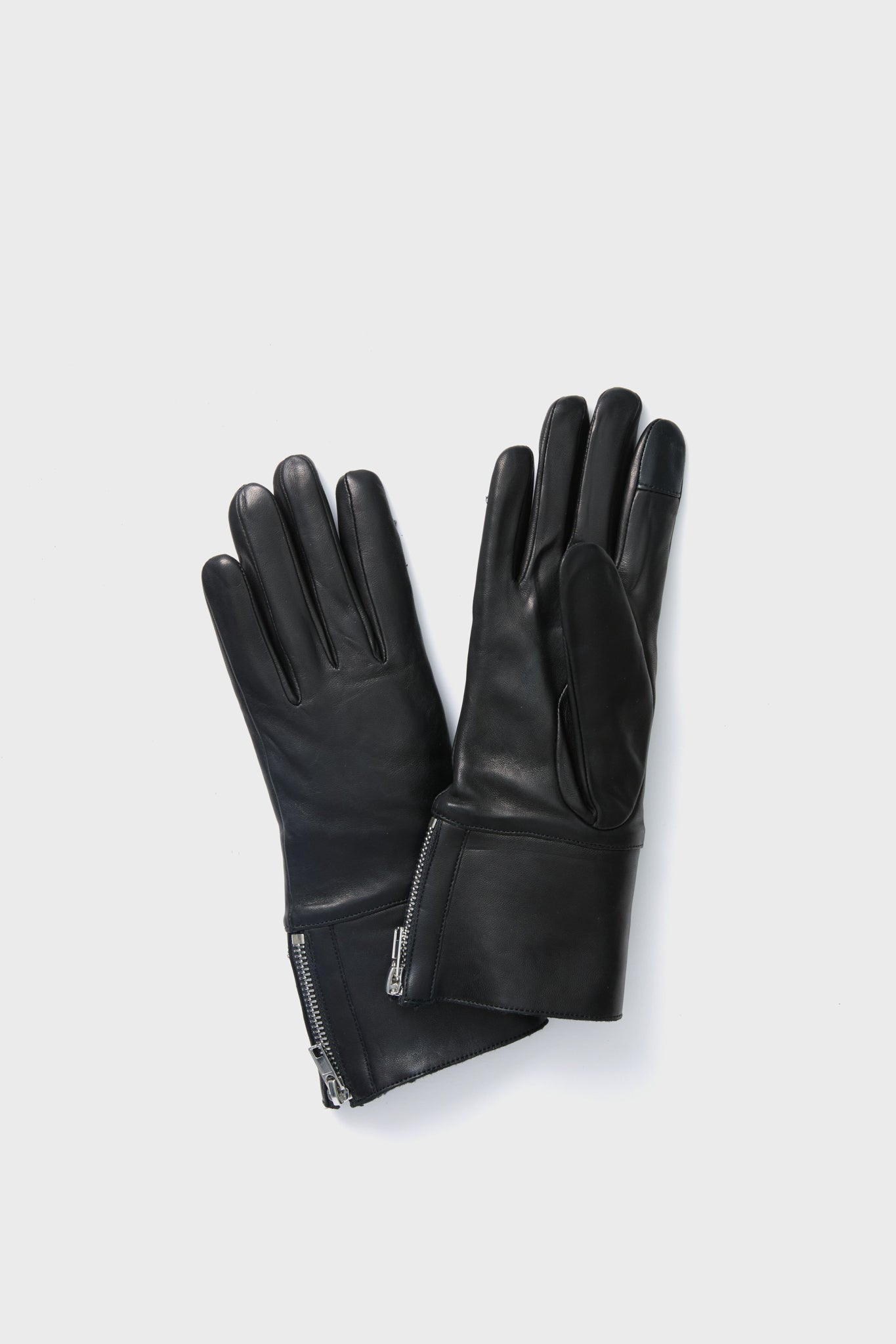 Carolina Amato black leather gloves with wrist zippers, designed to be touchscreen compatible for style and functionality.