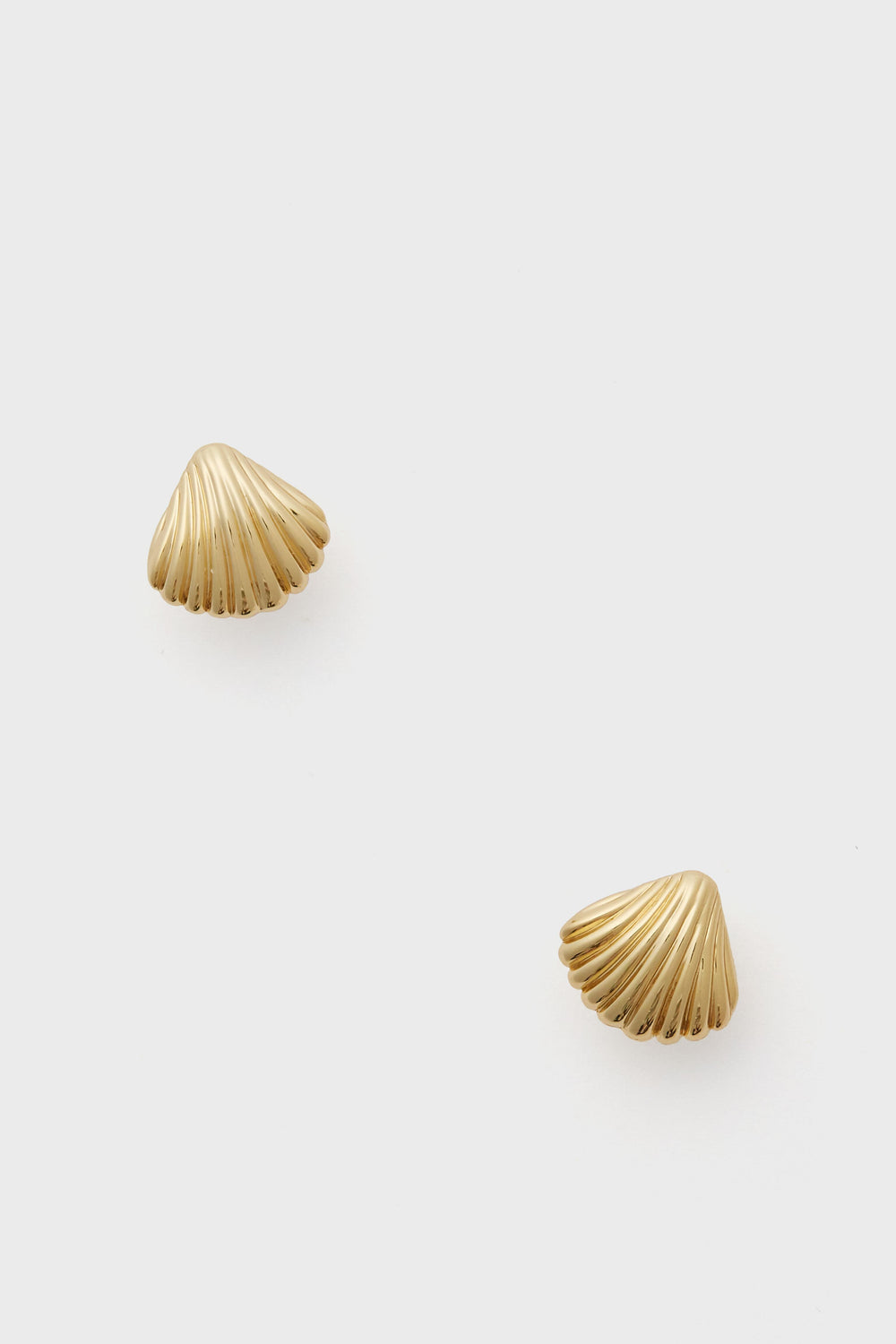 A pair of small gold shell stud earrings by Tuckernuck Jewelry, beautifully crafted and gold plated for a timeless look.