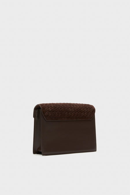 Brown Leather Stevie Crossbody features an effortless, high-end design with a classic woven suede flap, perfect for a fun, stylish addition to any fall outfit.
