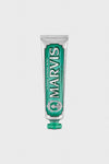 A tube of Marvis Classic Strong Mint Toothpaste stands upright with a green cap, delivering luxury dental care and long-lasting minty freshness.