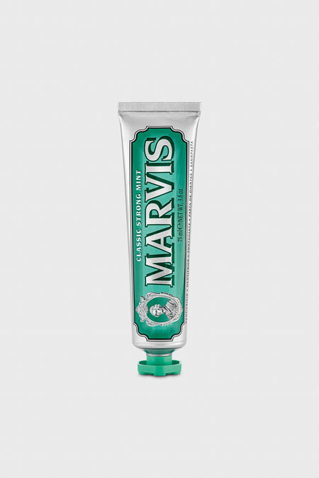 A tube of Marvis Classic Strong Mint Toothpaste stands upright with a green cap, delivering luxury dental care and long-lasting minty freshness.