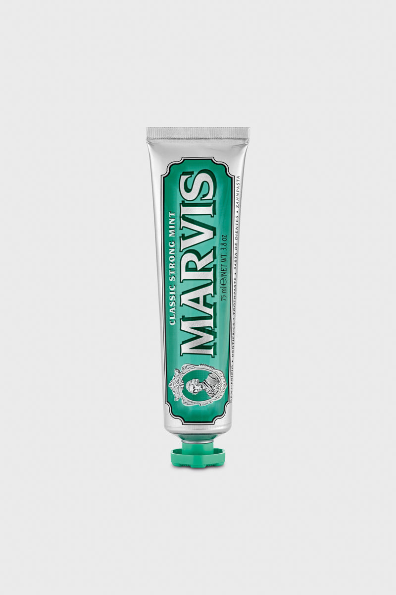A tube of Marvis Classic Strong Mint Toothpaste stands upright with a green cap, delivering luxury dental care and long-lasting minty freshness.