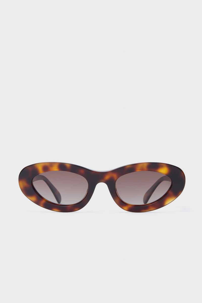 Anine Bing oval sunglasses featuring a tortoiseshell pattern, dark lenses, and polarized UV400 protection.
