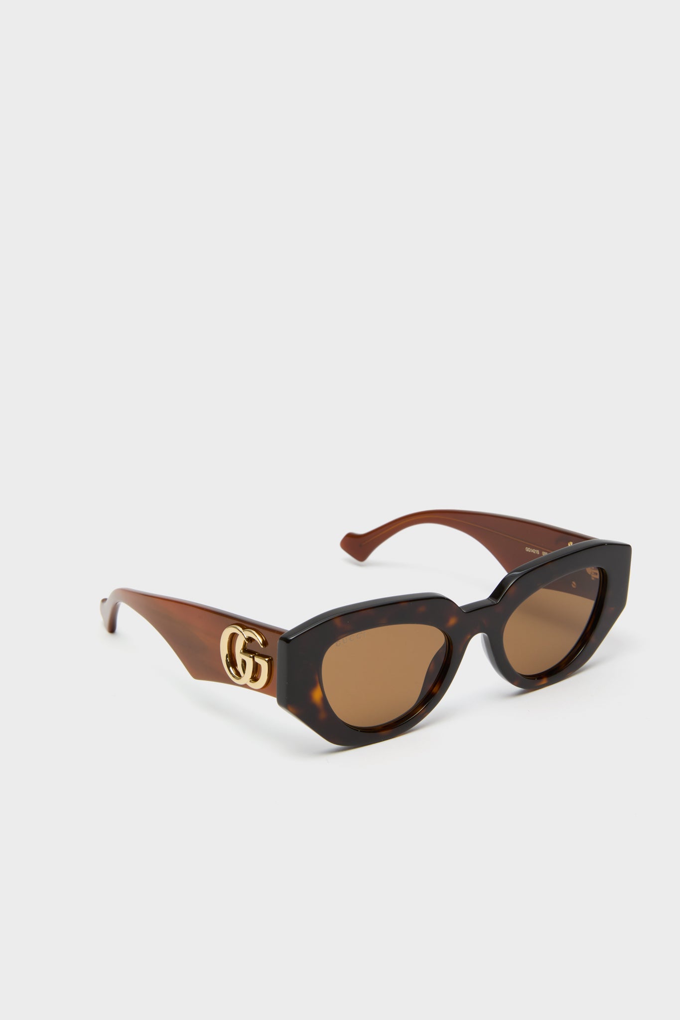 Shiny Dark Havana Cat-Eye Gucci Generation Sunglasses with a tortoiseshell acetate frame, gold GG logos, and brown lenses, exuding classic, effortless, high-end style.