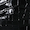 Close-up of a piano keyboard in black and white, highlighting several keys in partial view with high contrast lighting and a dramatic monochrome effect.