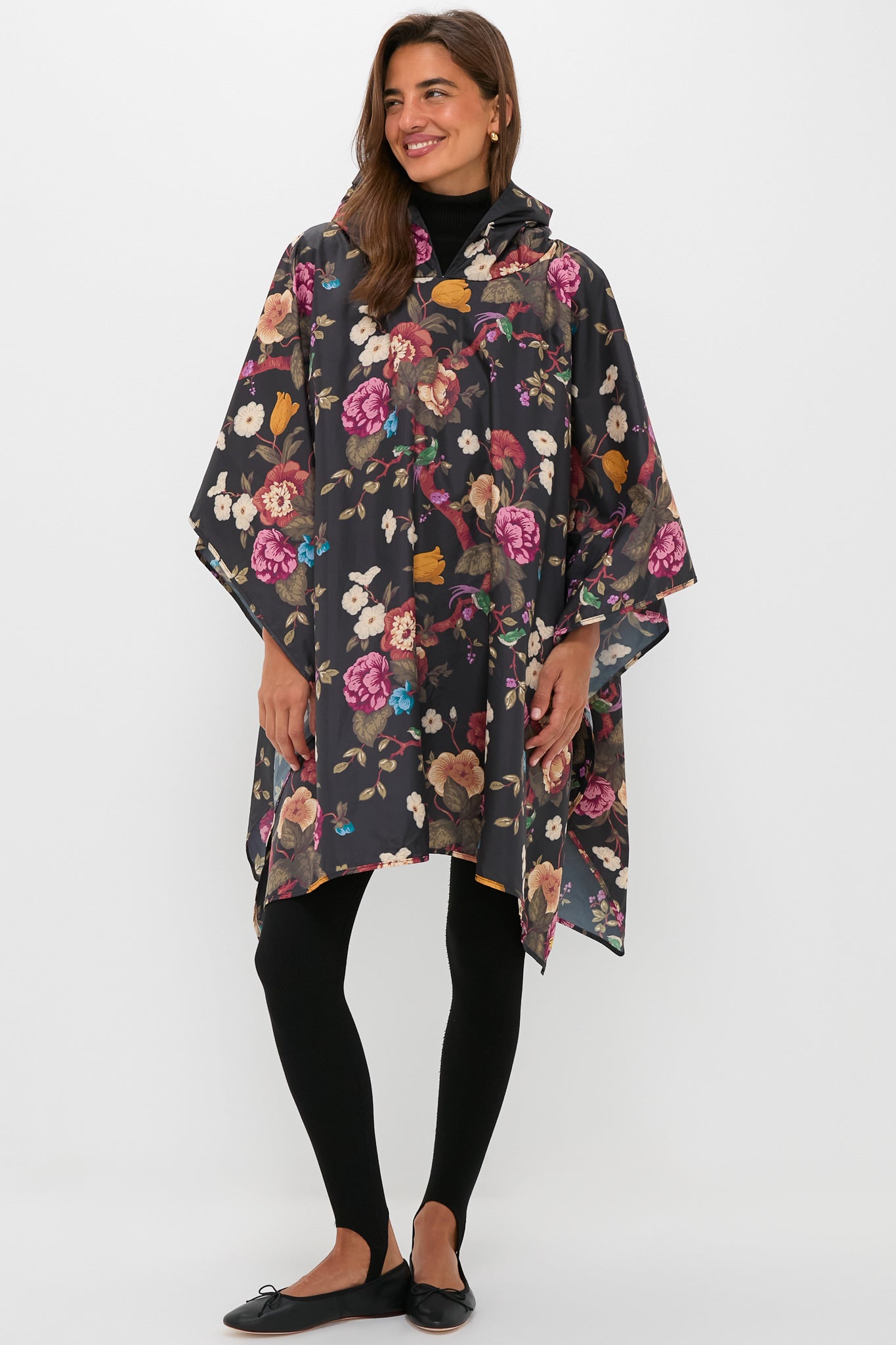 Model in a classic, high-end Black Floral Barbour x Tuckernuck Poncho, showcasing effortless style with its fun, bold floral print and versatile, rainy-day functionality.