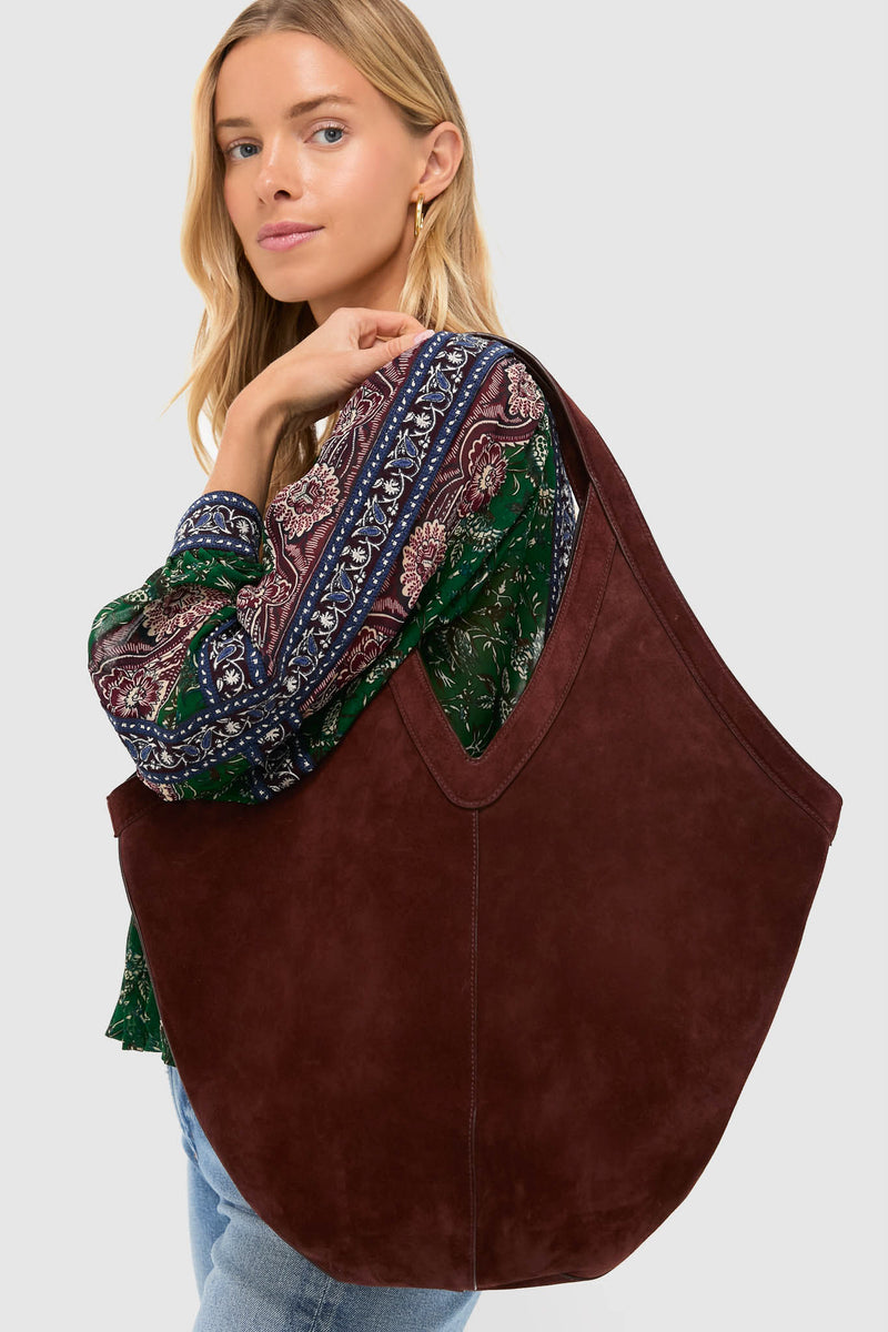 Model with classic Chocolate Soft M Hobo tote, showcasing effortless style with its versatile design and high-end Italian suede, paired with a bohemian blouse and jeans.