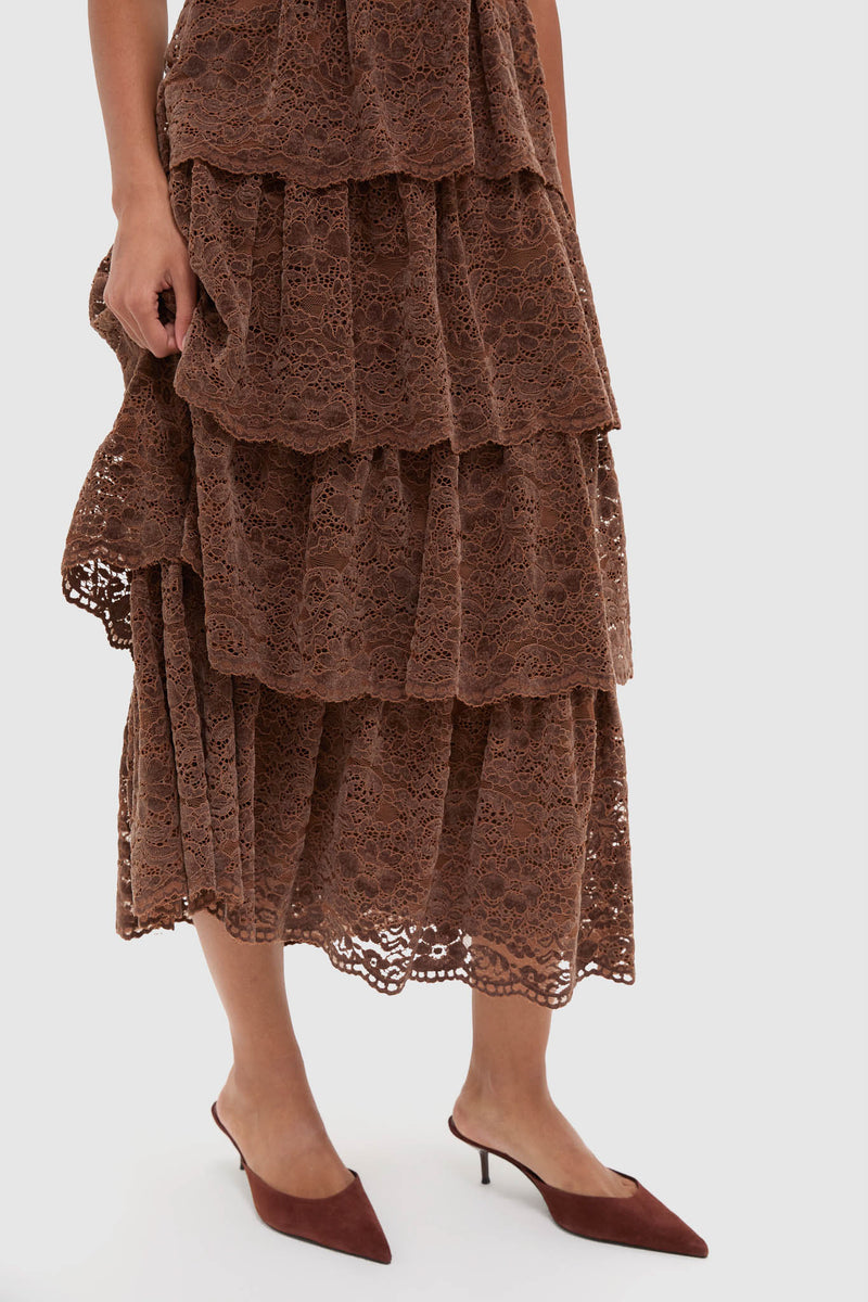 Model showcasing the Sepia Lace Leina Midi Dress, featuring a tiered lace skirt paired with brown suede kitten heels, exuding a classic and effortless high-end style.