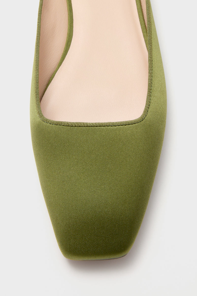 Fern Satin Nilli Flats feature a classic mule silhouette with an effortless, softly squared-off toe and olive-green satin finish, perfect for fun, high-end everyday wear.