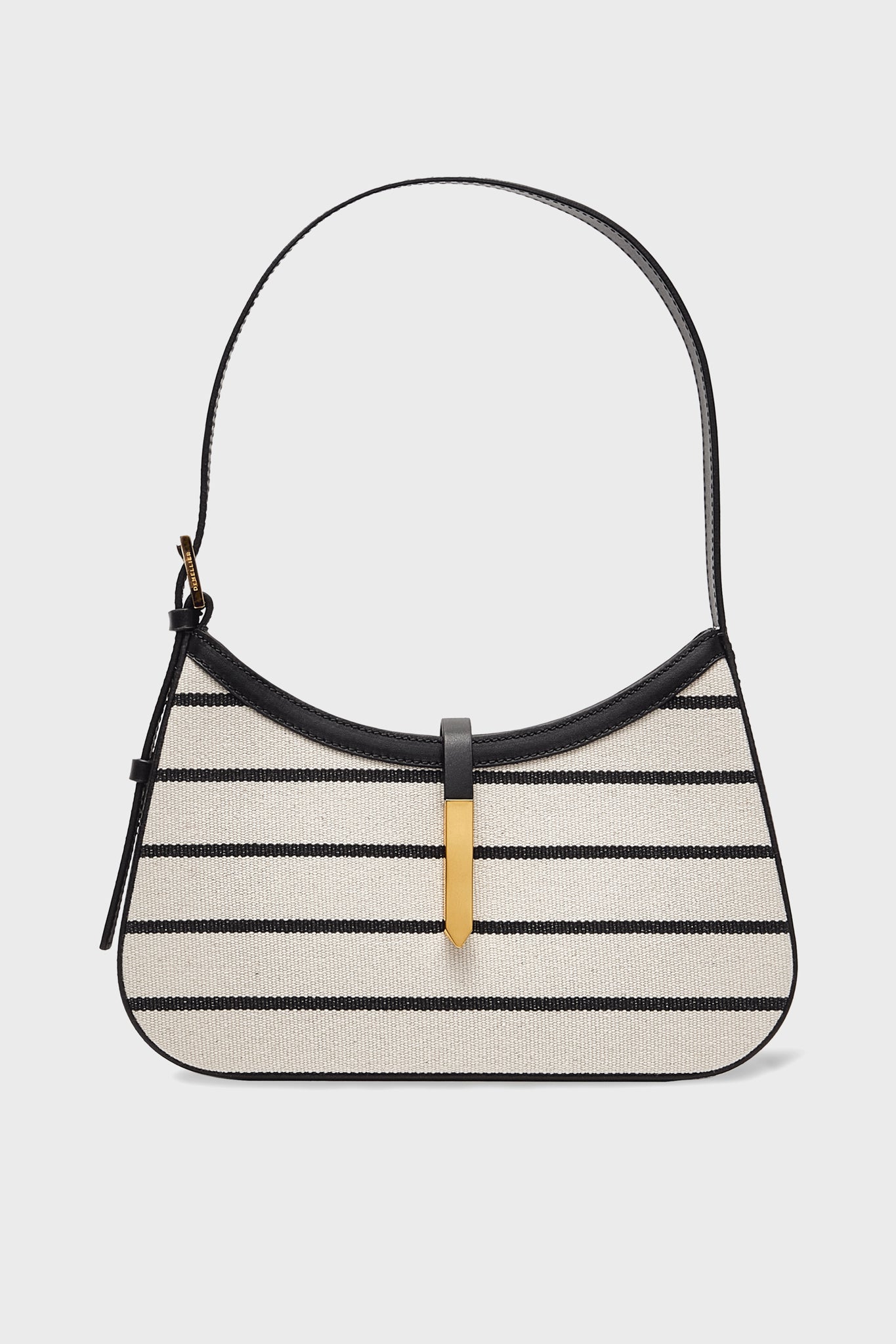 The Demellier Tokyo bag is a beige mini hobo with black horizontal stripes, black trim, a single shoulder strap, and a gold-tone front clasp. Made of canvas, this handcrafted handbag is perfect for stylish accessory lovers.