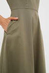 Close-up of the Burnt Olive Chino Solen Midi Dress featuring a classic A-line silhouette, hidden side pocket, and waist seam, embodying effortless, high-end style.