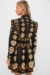 Back view of a woman in a classic, high-end Black Embroidered Flowers Topstitching Long Sleeve Mini Dress, showcasing an effortless, fun style with bold floral motifs.