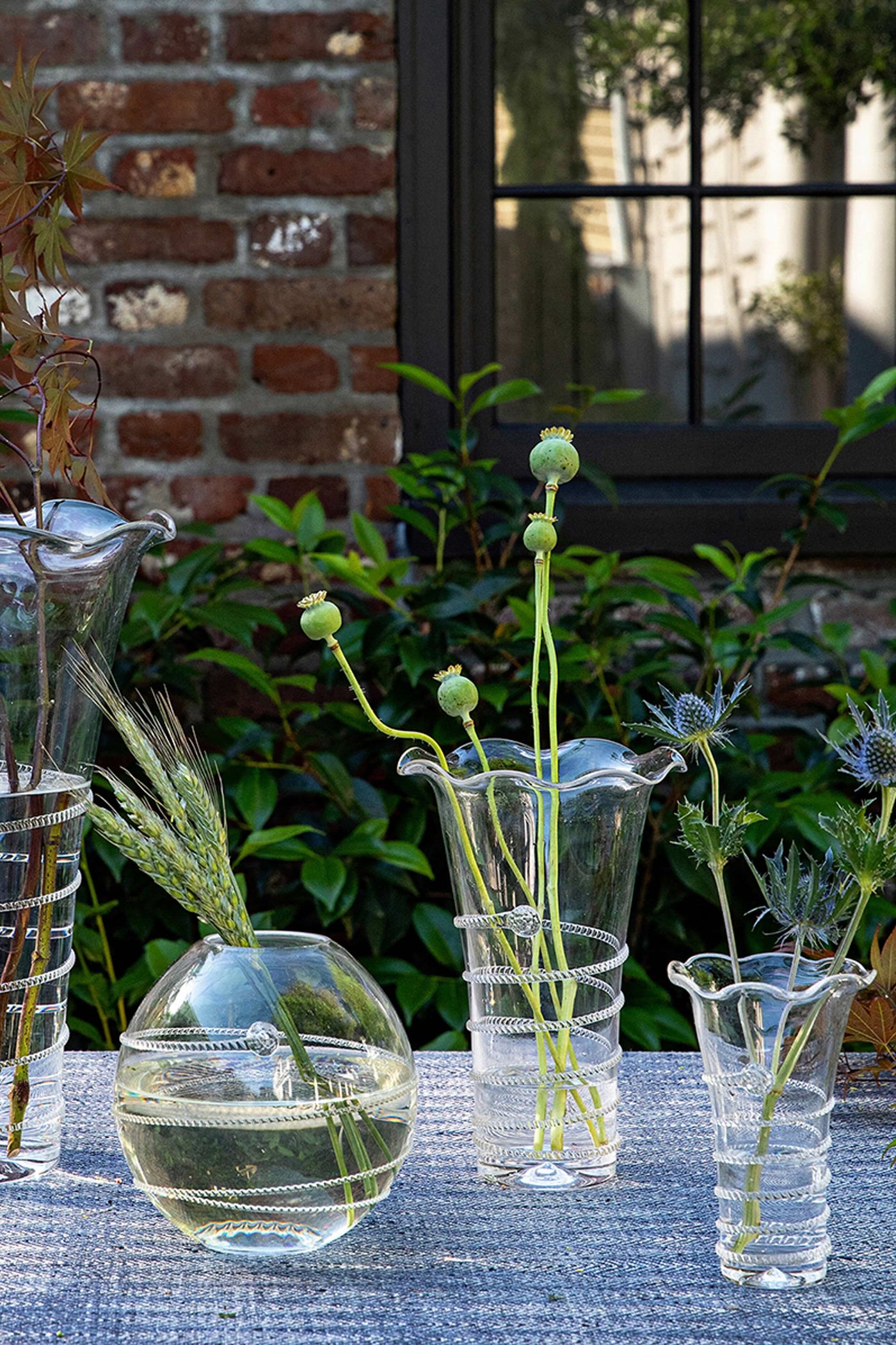 Amalia 6 Flared Vase, wrapped in decorative metal bands, elegantly showcases botanical stems, embodying classic, effortless, and high-end style for a fun, sophisticated touch.