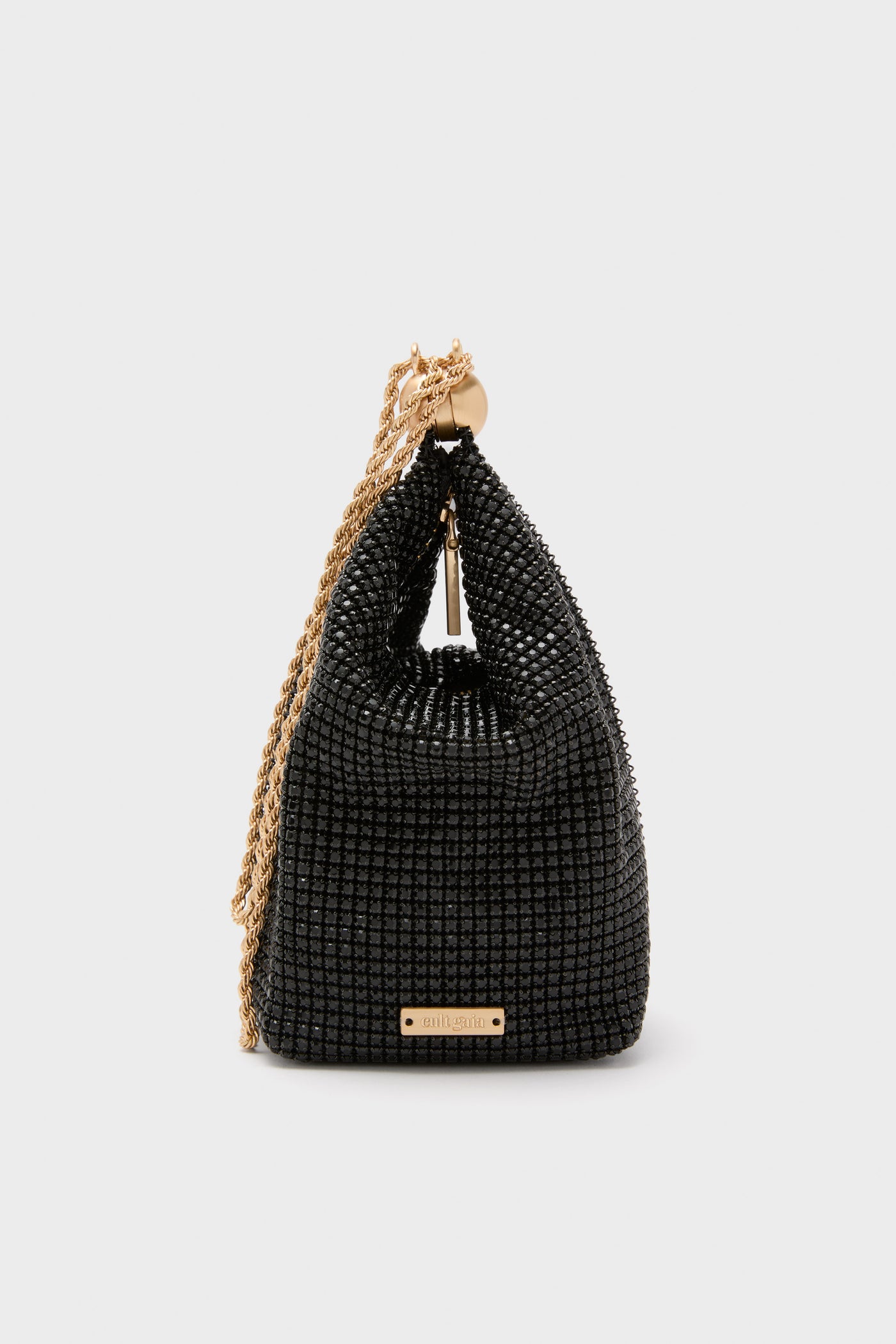 Classic and high-end, the Black Rue Wristlet by Cult Gaia features a glossy beaded mesh with a twisted gold-tone chain, exuding effortless elegance and fun.