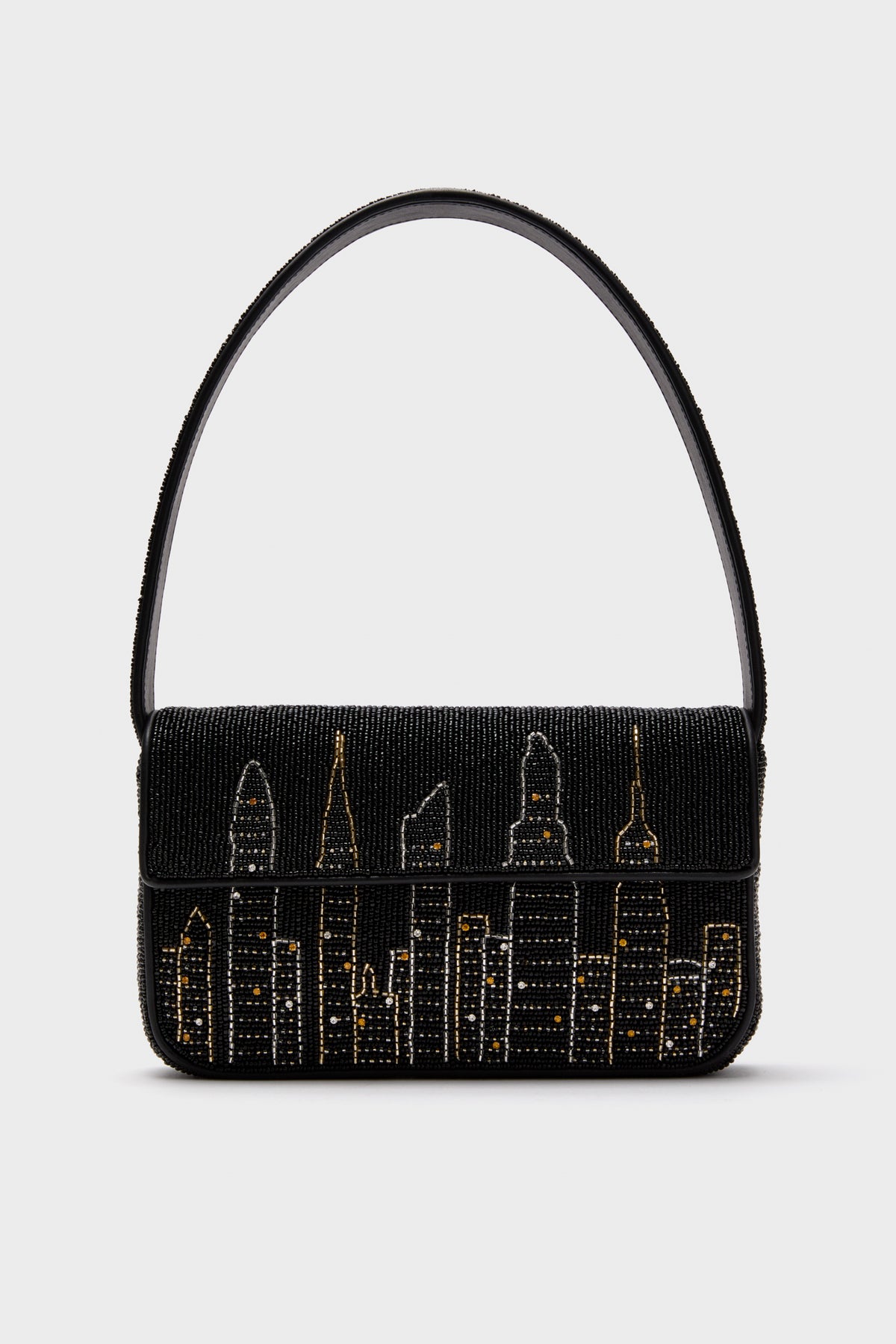 STAUD’s black Tommy Bag features hand-beaded gold and silver city skyline details and a single shoulder strap.