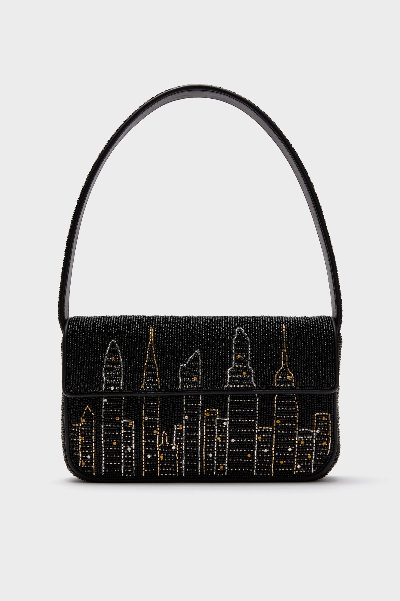 STAUD’s black Tommy Bag features hand-beaded gold and silver city skyline details and a single shoulder strap.