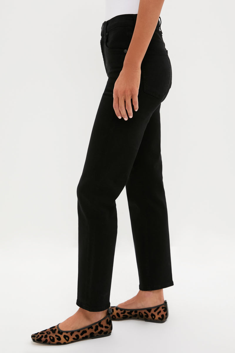 A person stands sideways against a plain white background, wearing Citizens of Humanity high-rise straight leg jeans in black and leopard print flats.