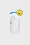 Chambray Nell Highball: A classic, high-end glass with ribbed texture, filled with fizzy liquid and lime garnish, embodies effortless fun for stylish cocktail moments.