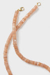Peach Moonstone Candy Necklace: Classic, effortless strand of shimmering peach-hued beads with gold-tone lobster clasp. Perfect for fun, high-end style and layering versatility.