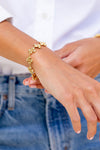 Berry Clover Linear Bracelet, 7+2 - Gold: A classic, effortless bracelet with flower-shaped links and textured gold details, exuding high-end charm for a fun, versatile ensemble.