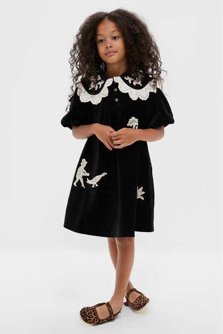 Young girl wearing classic Leopard Mary Jane Flats, effortlessly stylish with a fun, high-end touch, featuring adjustable velcro and rubber soles for adventurous steps.