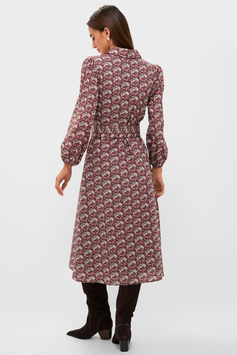Woman wearing the classic Plum & Dusty Blue Leafy Floral Kai Maxi Dress with a fitted waist, fold-over collar, and knee-high boots, exuding effortless, high-end style.