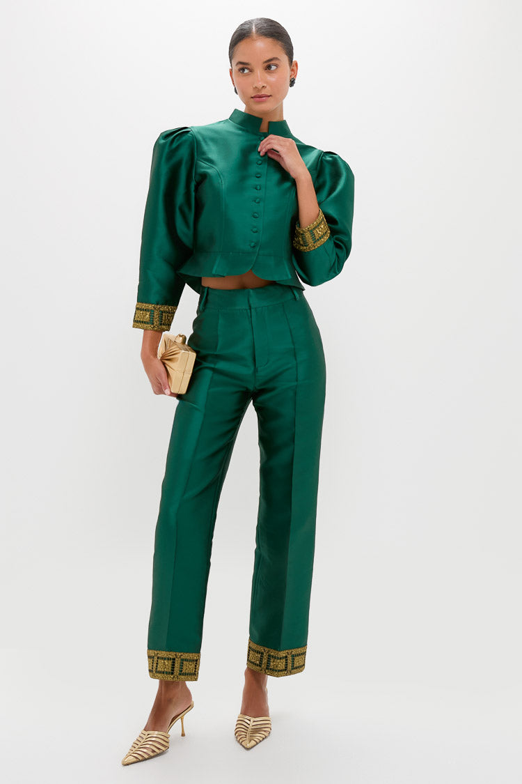 Model in emerald-green satin outfit, showcasing Navy Crystal Emaline Studs with classic deep navy stones in gold-plated brass, effortlessly adding a high-end, fun touch.