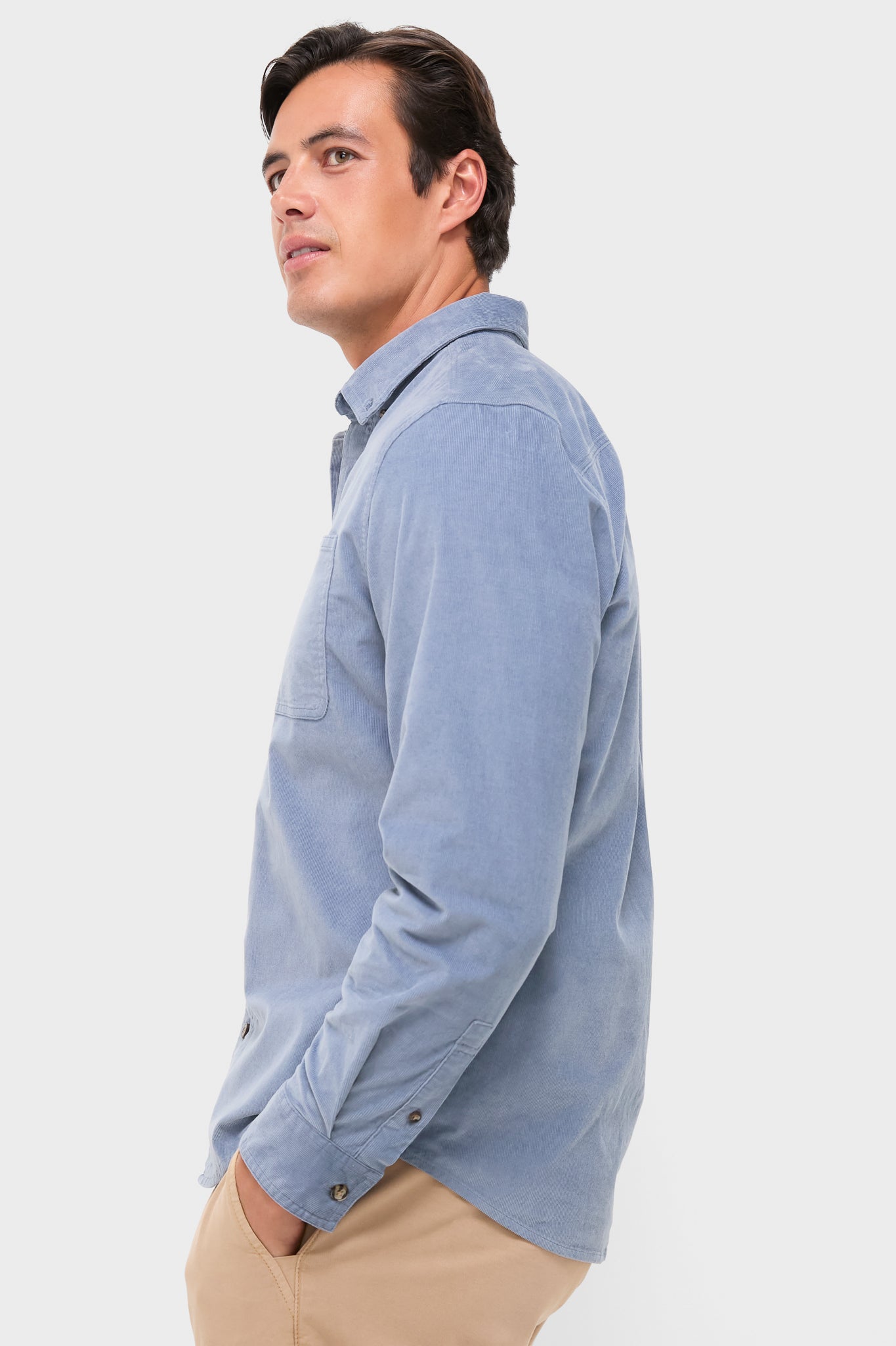 Man in profile wears the Maritime Wilder Stretch Corduroy Shirt, showcasing a classic, effortless style. The light blue shirt offers a fun, high-end look perfect for transitional seasons.