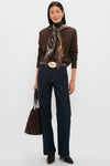Woman wearing classic, high-end outfit featuring the Gold Celeste Buckle with a chic, oversized oval design, adding effortless elegance to her ensemble.