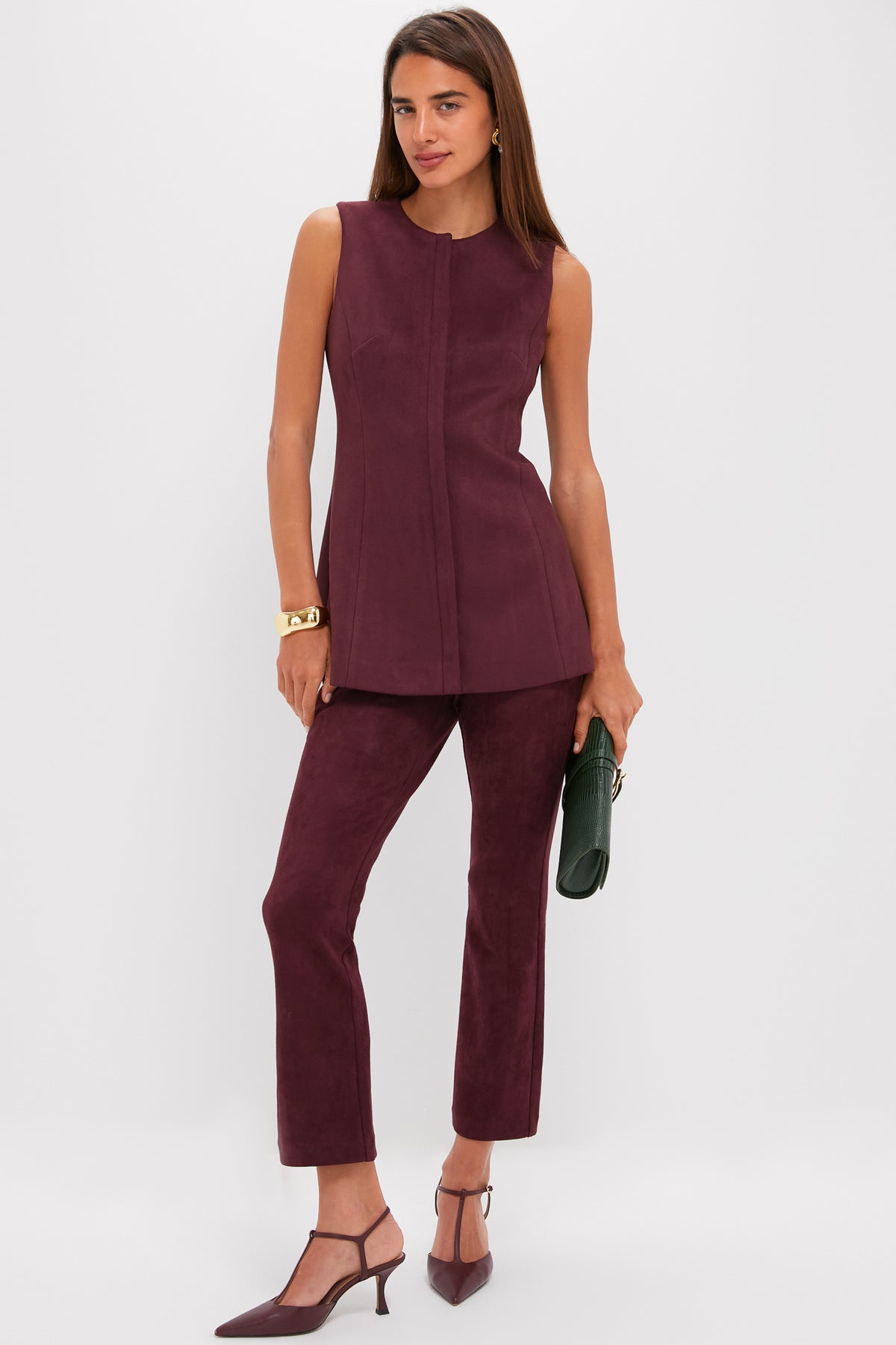 Model wearing classic Winetasting Vegan Suede Ashford Pants with a coordinated tunic, showcasing an effortless, high-end look with fun T-strap heels and a dark green clutch.