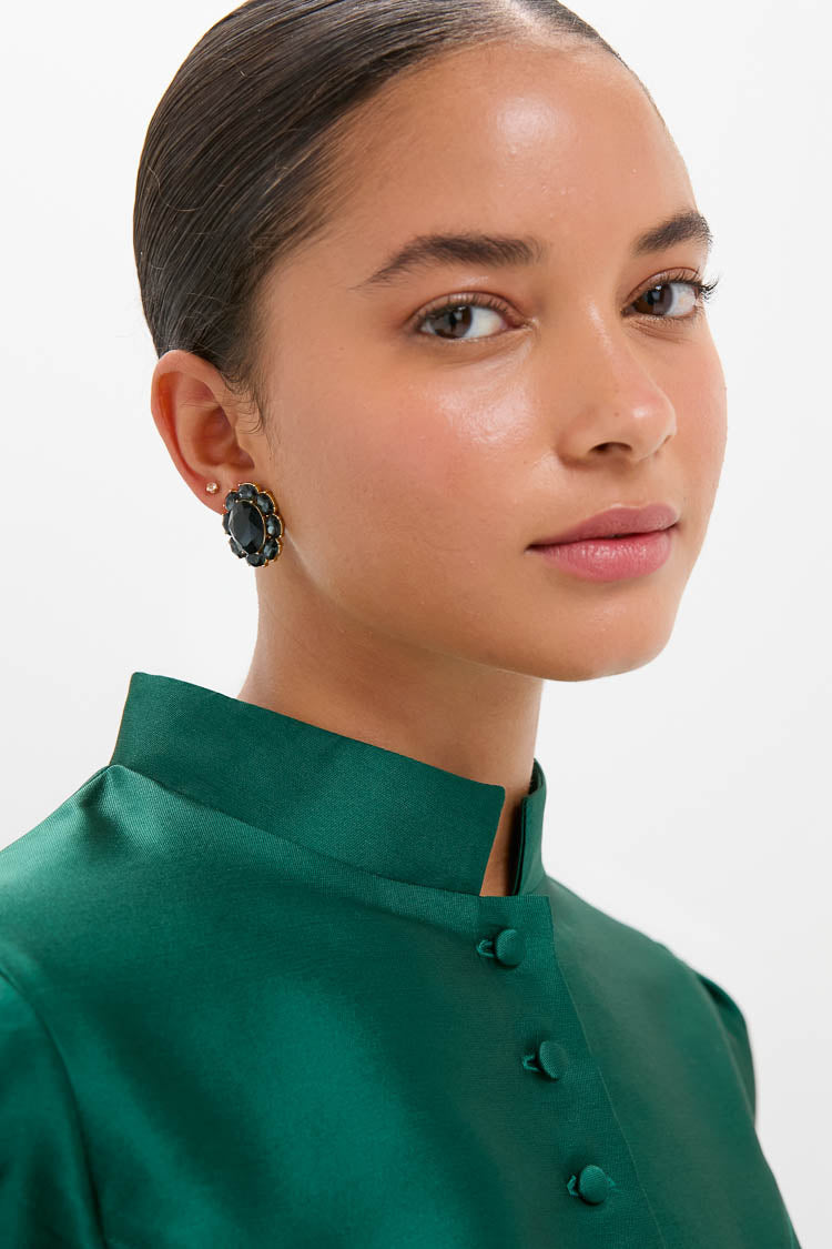 The Navy Crystal Emaline Studs: classic, high-end flower-shaped earrings with navy stones, gold-tone frame, offering an effortless, fun elegance for any look.