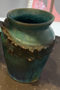 A Tuckernuck Vintage Accessories ceramic vase with a blue-green glaze, textured irregular band around the middle, and slightly flared rim, displayed on a dark surface.