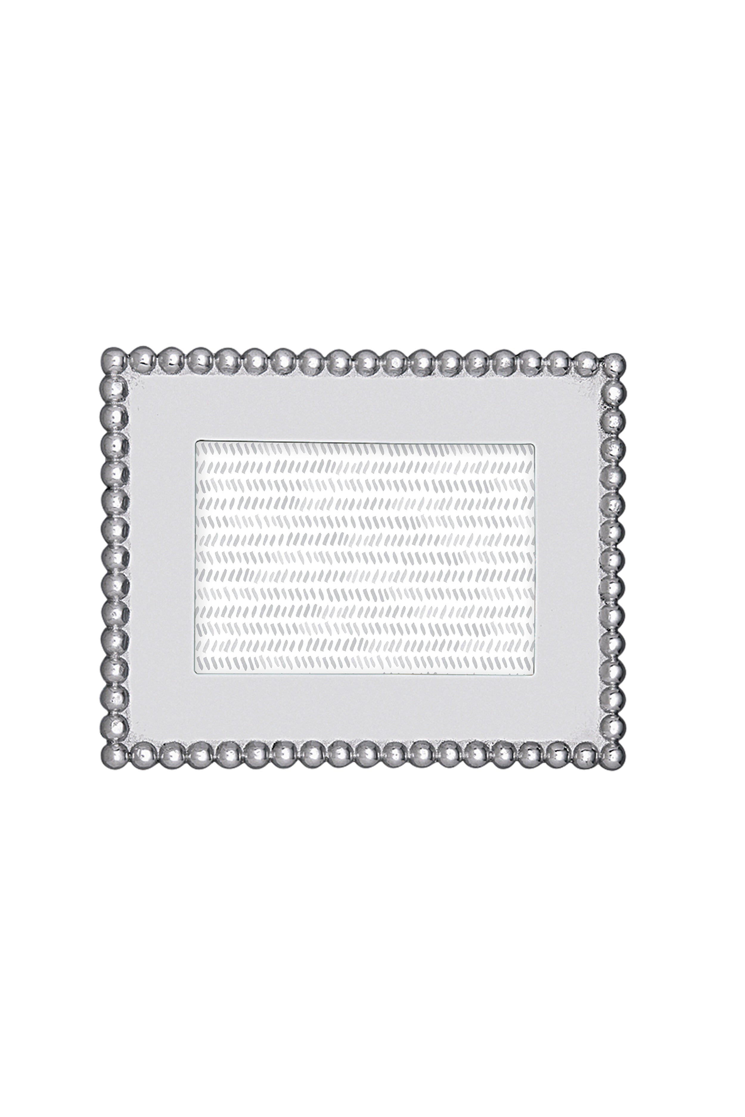 The Mariposa rectangular silver recycled aluminum frame features a beaded border and textured inner section, handcrafted for 4x6 photos—an ideal housewarming gift.