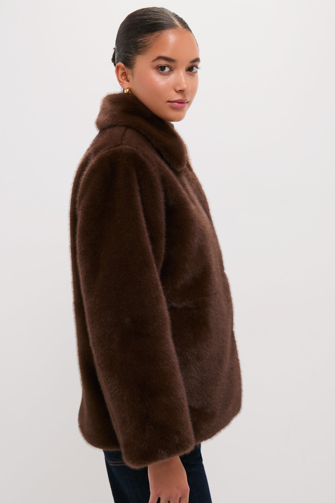Slim-built person in a rich chocolate-brown Dark Brown Faux Fur Brooke Cardigan, showcasing a classic, effortless style with a plush texture, exuding fun and high-end fashion.