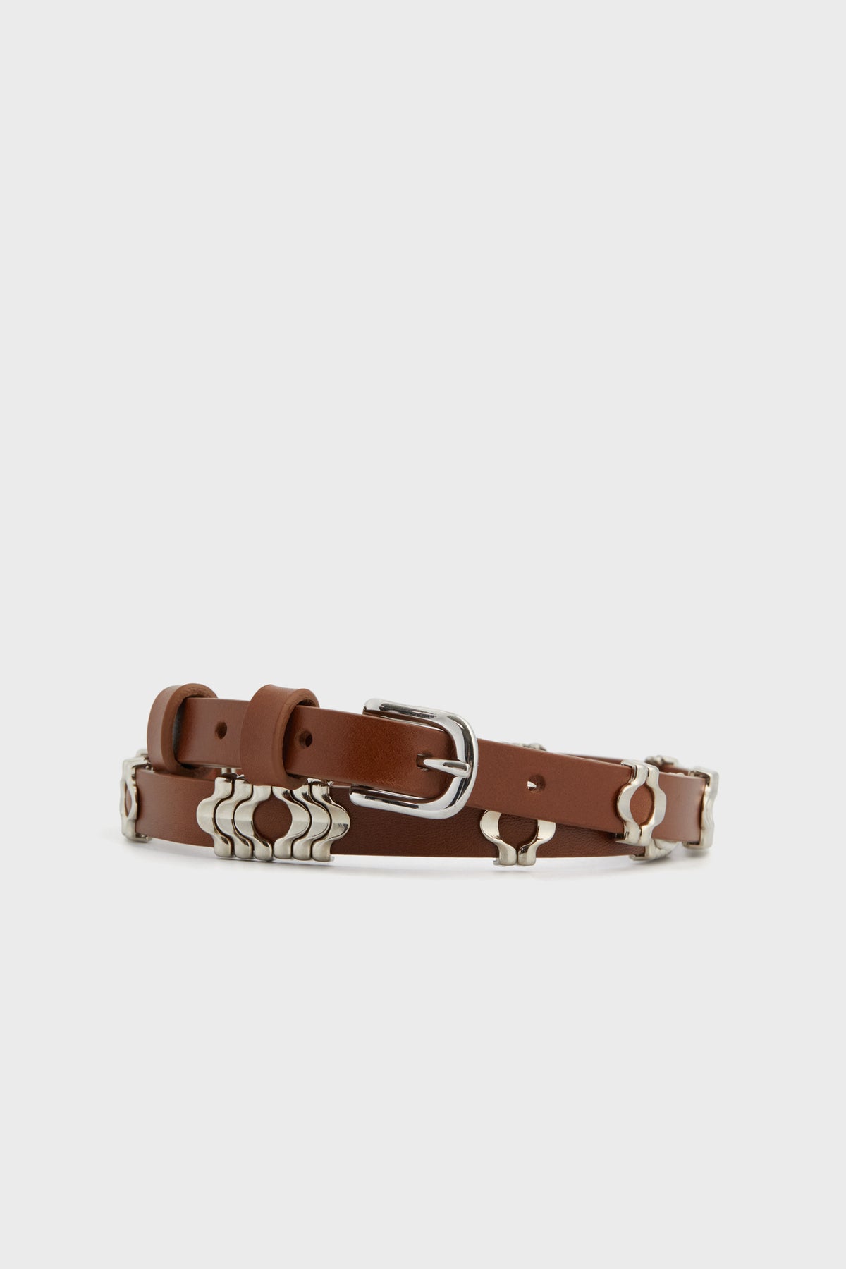 The Isabel Marant Odena Belt features brown luxe leather in cognac, a silver metal buckle, and decorative silver hardware along the strap.