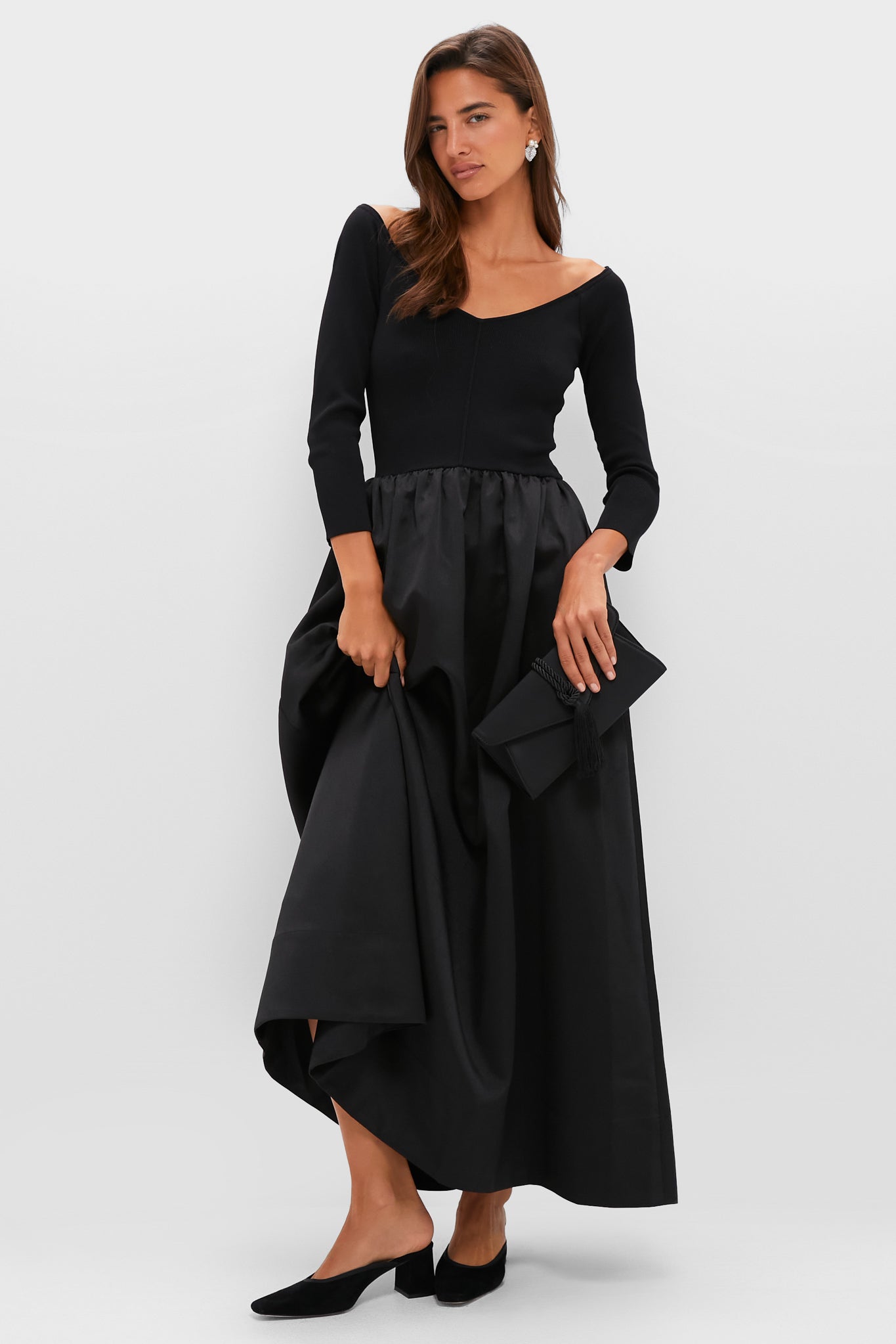 Woman models Crystal Pearl Blanca Earrings with classic evening dress. Earrings feature sparkling pavé crystals, pearls, adding effortless elegance for high-end occasions.
